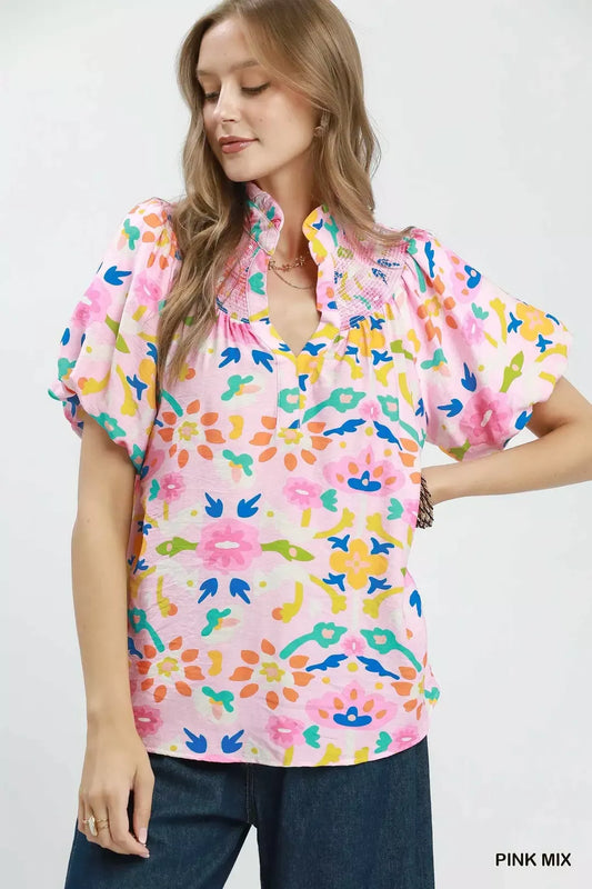 Pink mix folk art floral blouse with smocked neckline detail, split collar, puff sleeves, and relaxed boxy fit.
