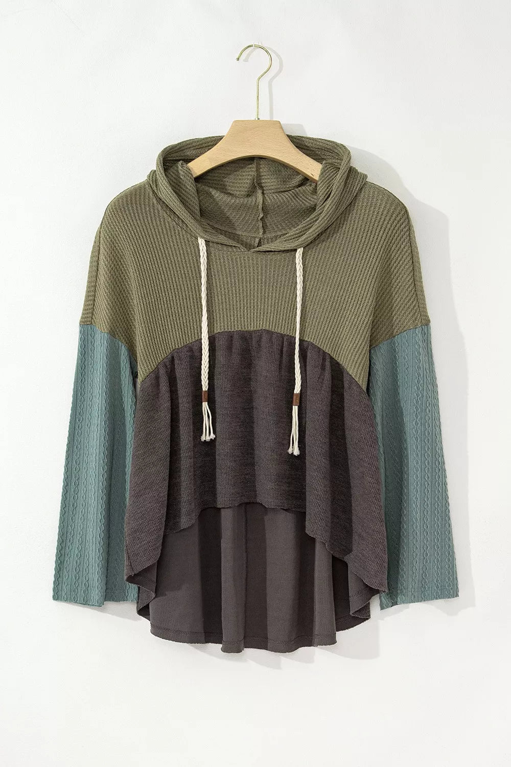 Woman wearing a colorblock drawstring hoodie with distressed jeans outdoors
