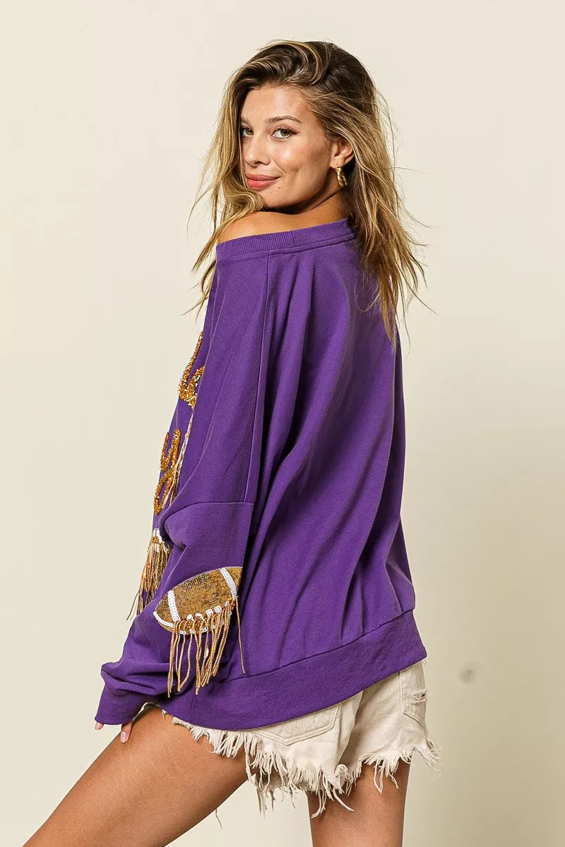 Purple sequin football patch game day sweatshirt with gold sequin lettering, oversized fit, and cozy long sleeves