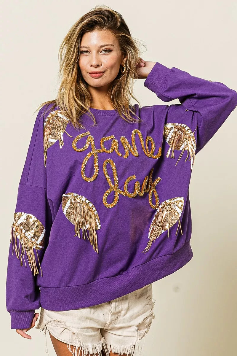 Purple sequin football patch game day sweatshirt with gold sequin lettering, oversized fit, and cozy long sleeves