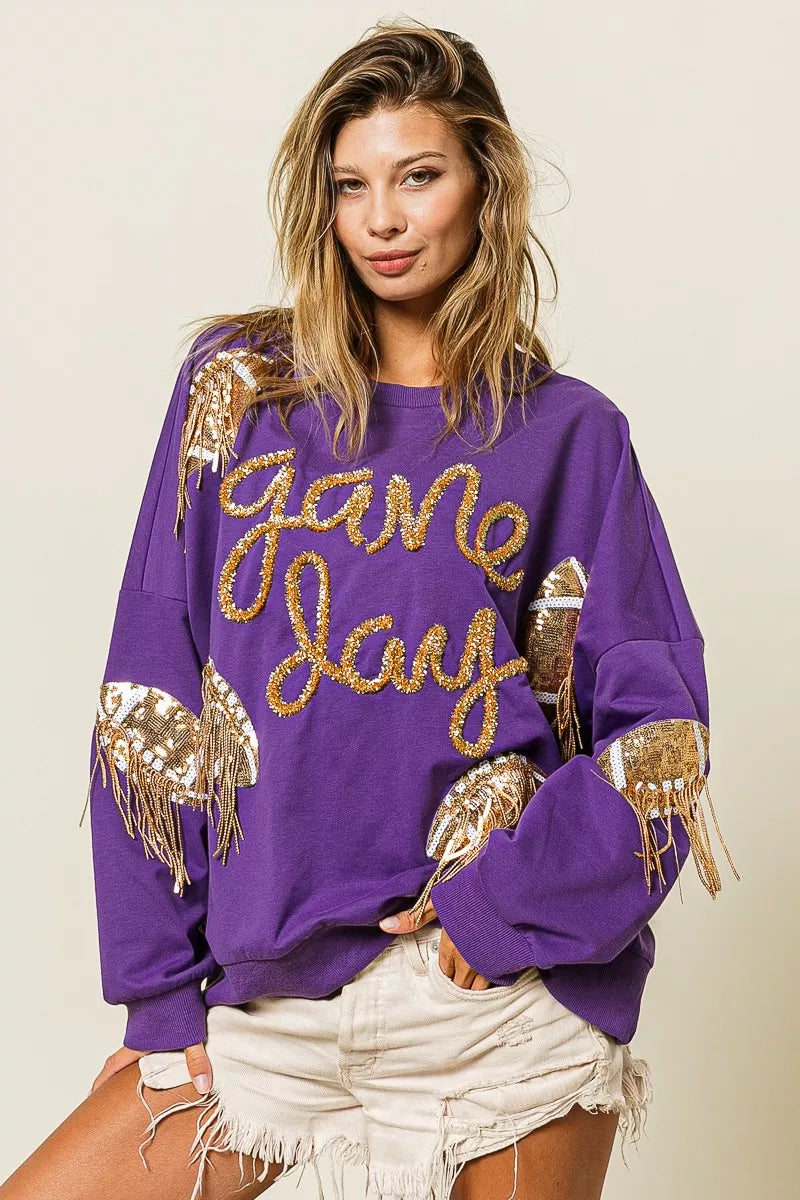 Purple sequin football patch game day sweatshirt with gold sequin lettering, oversized fit, and cozy long sleeves