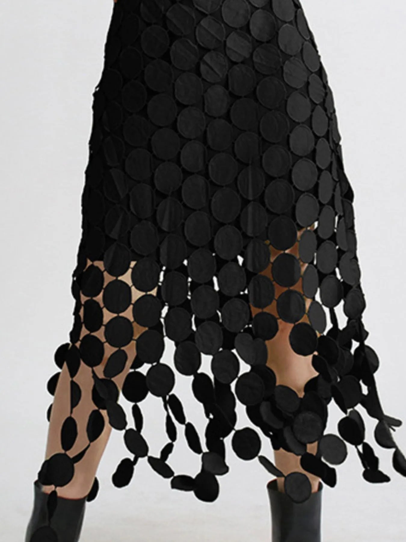 Black fringe midi skirt with cutout circles and flowing fringe detail