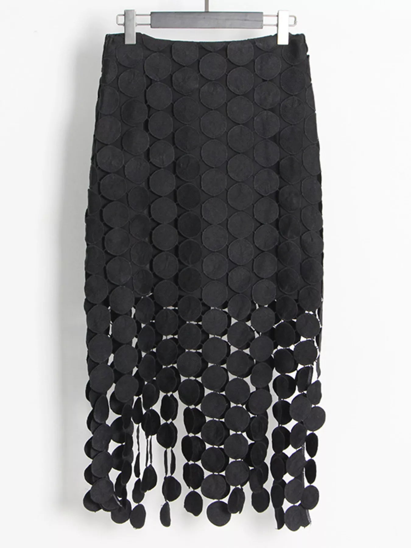 Black fringe midi skirt with cutout circles and flowing fringe detail