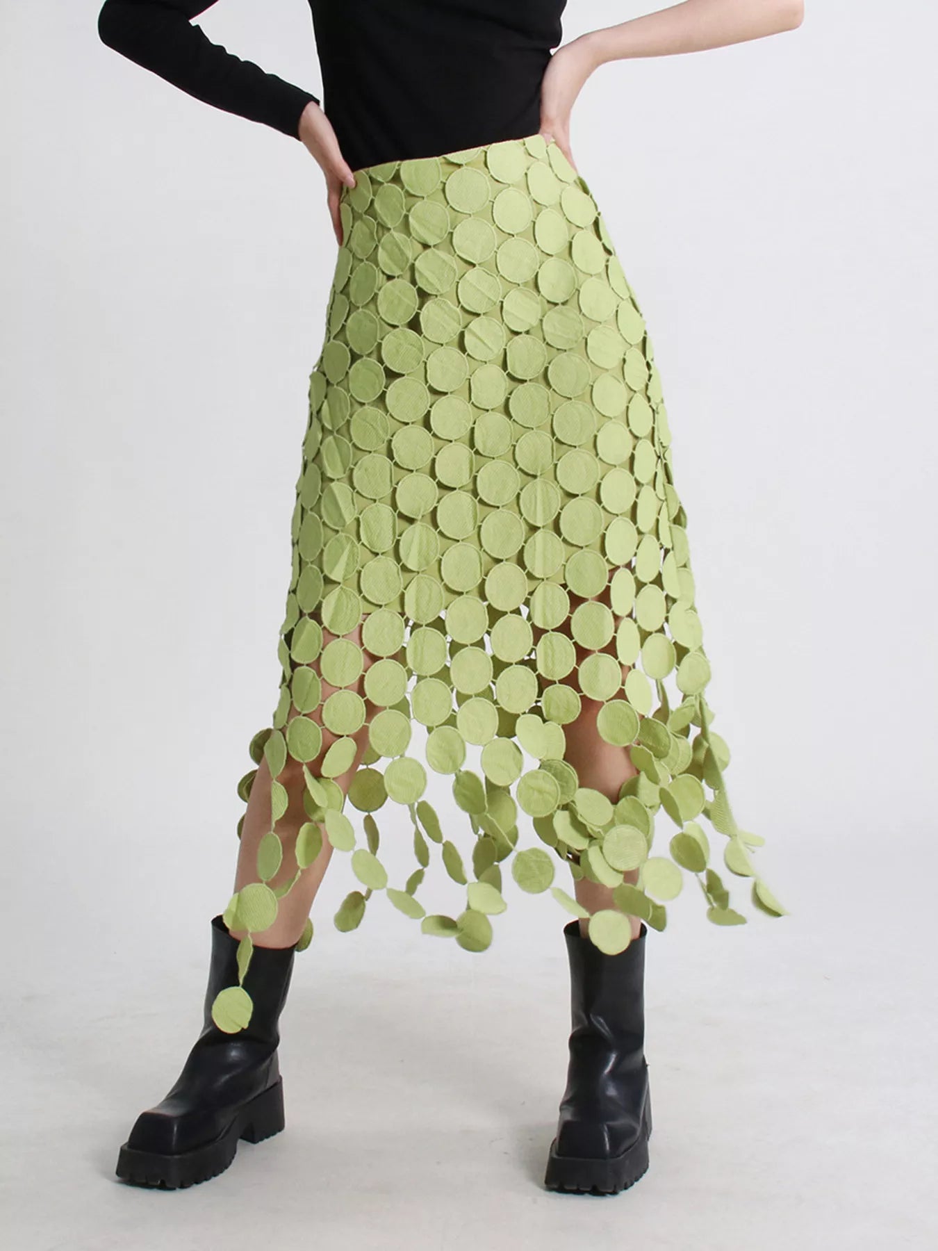 Green fringe midi skirt with cutout circles and flowing fringe detail