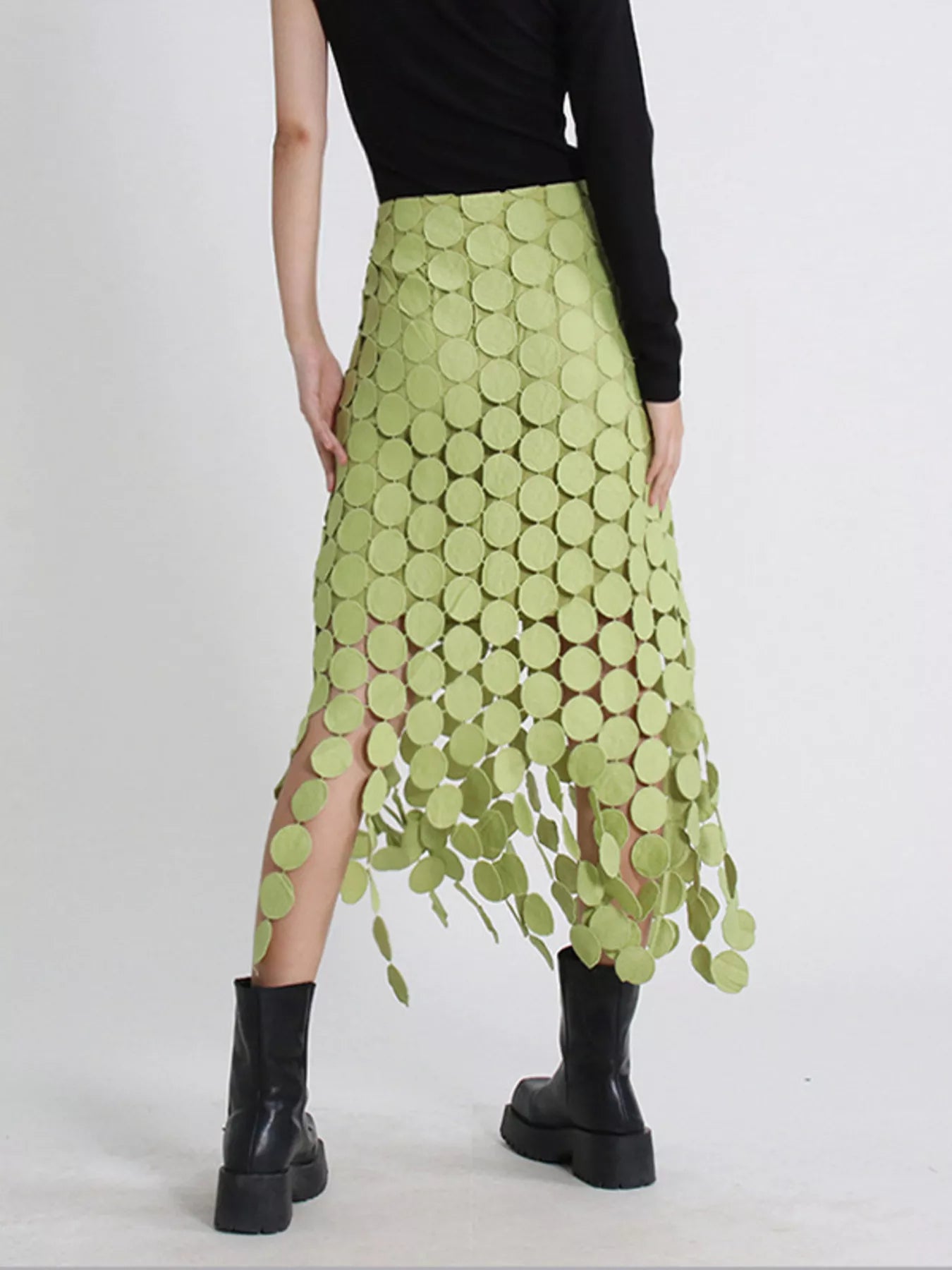 Green fringe midi skirt with cutout circles and flowing fringe detail