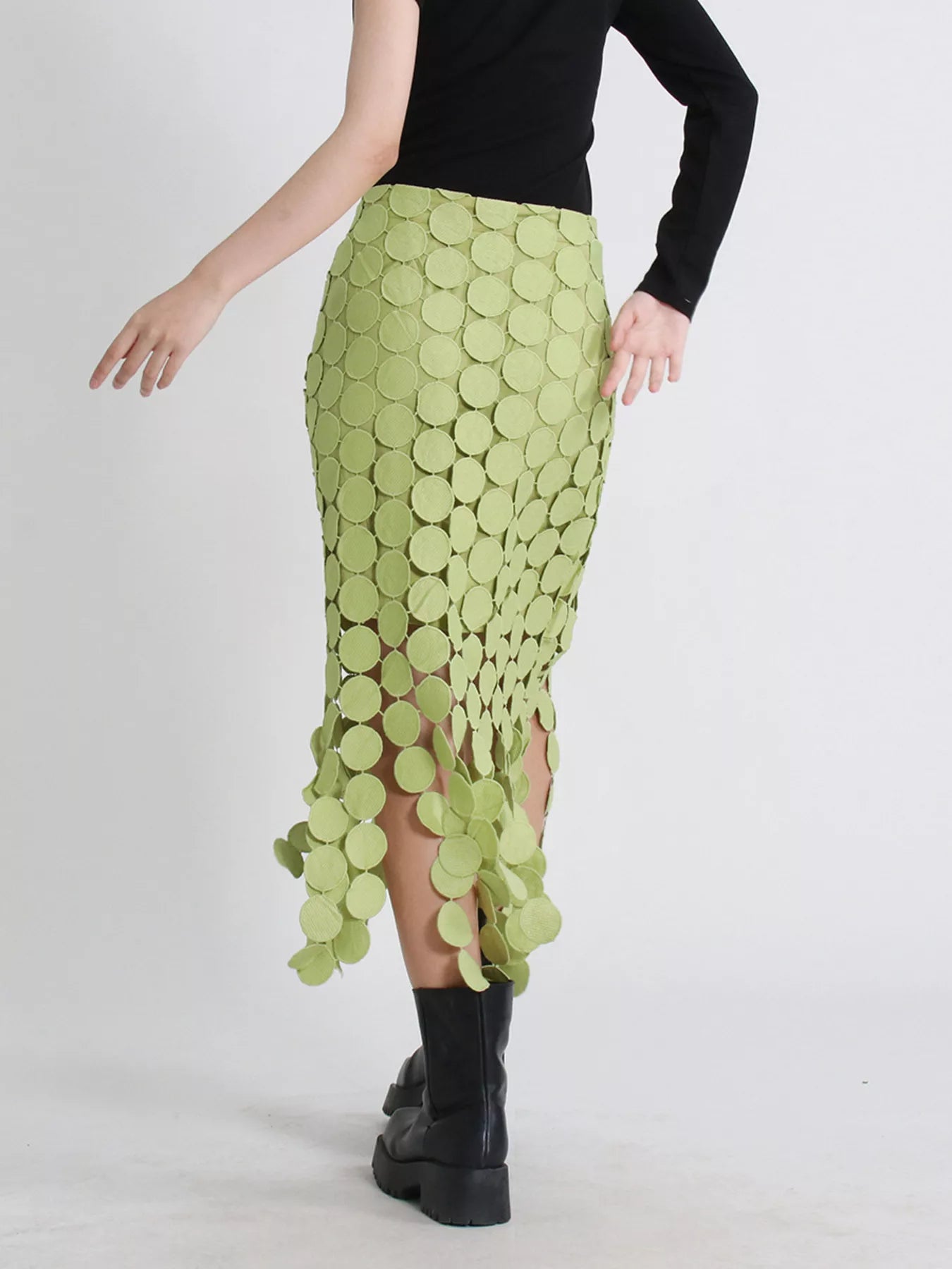 Green fringe midi skirt with cutout circles and flowing fringe detail