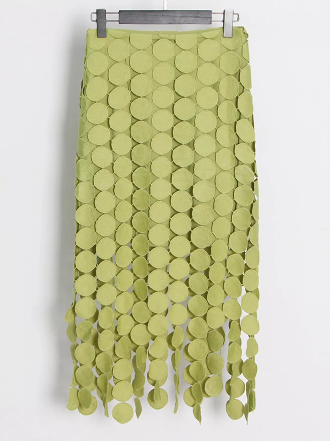 Green fringe midi skirt with cutout circles and flowing fringe detail
