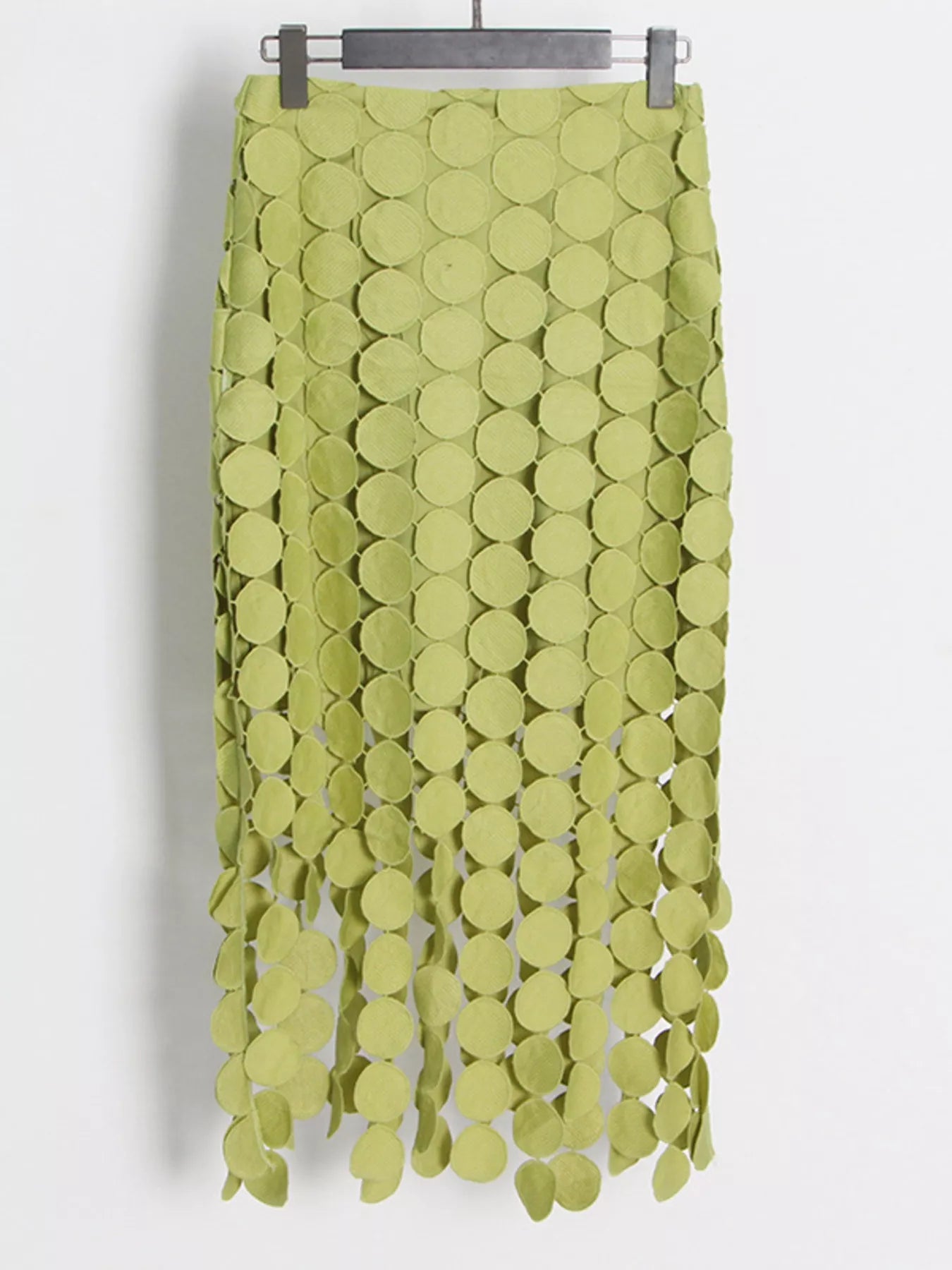 Green fringe midi skirt with cutout circles and flowing fringe detail