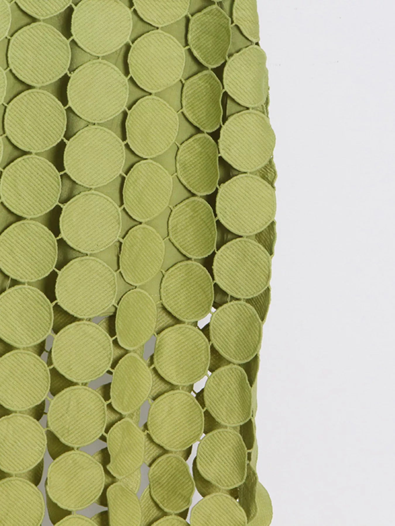 Green fringe midi skirt with cutout circles and flowing fringe detail