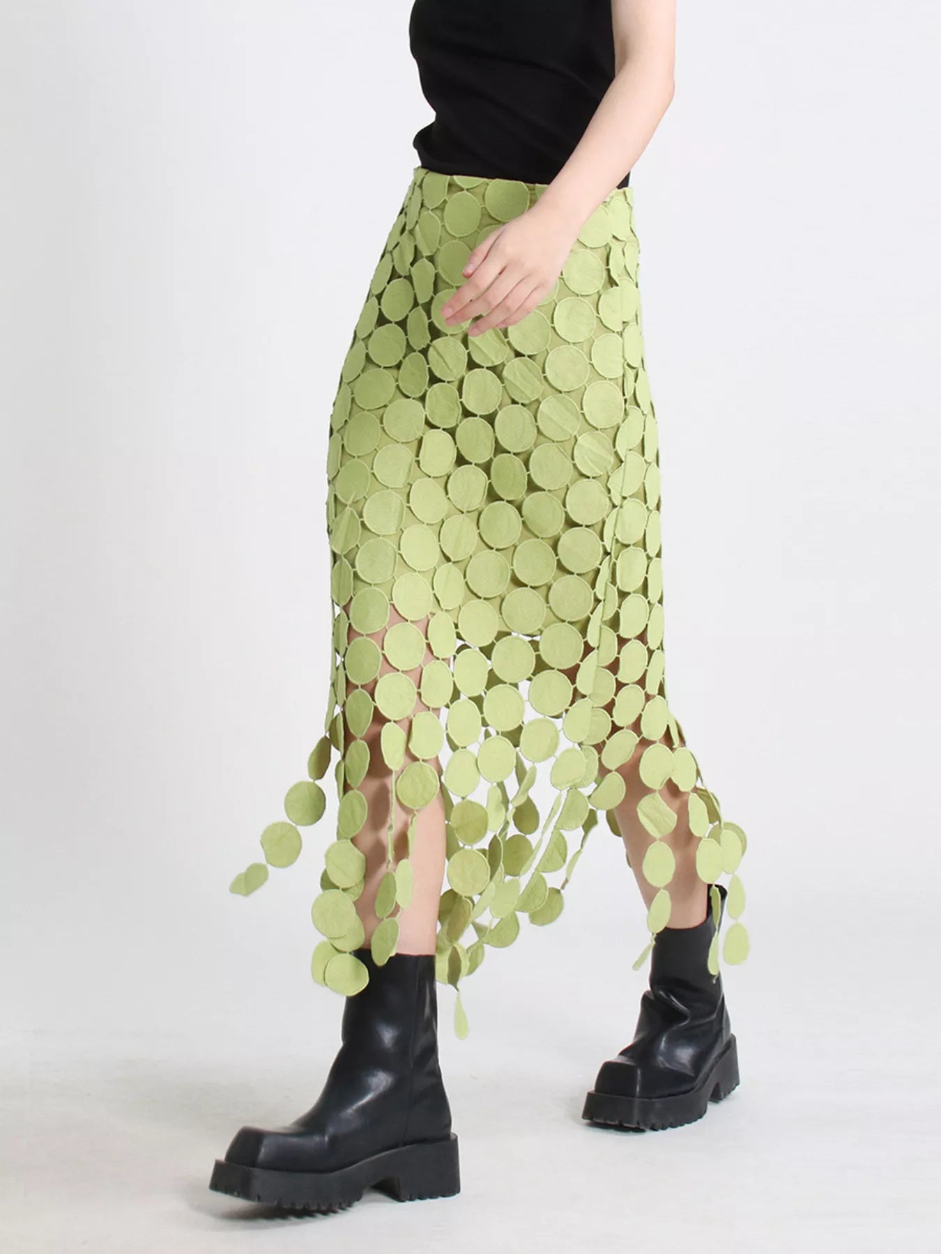 Green fringe midi skirt with cutout circles and flowing fringe detail