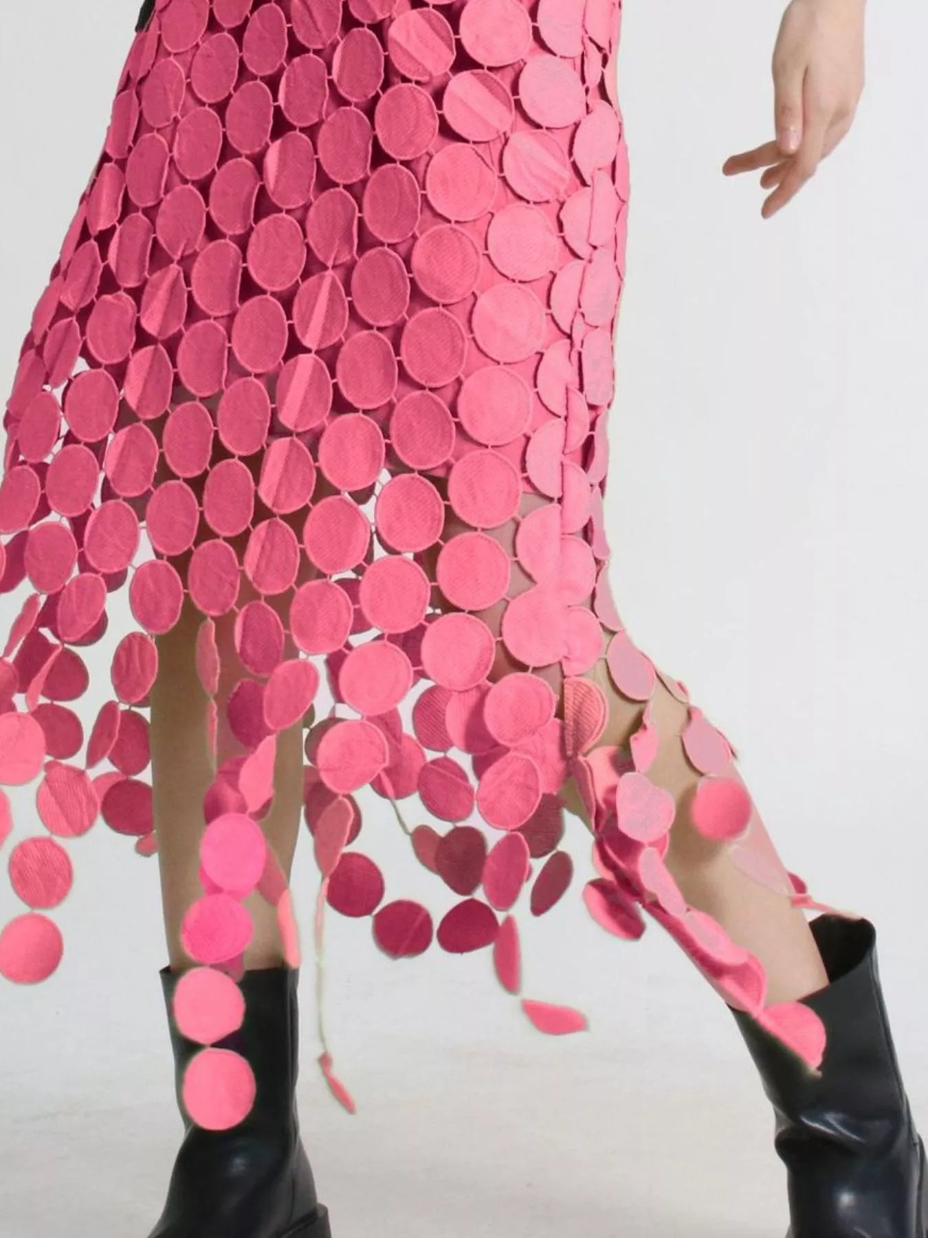 Pink fringe midi skirt with circular cutouts and asymmetrical hem