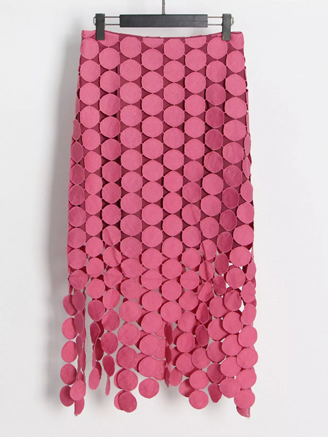 Pink fringe midi skirt with circular cutouts and asymmetrical hem
