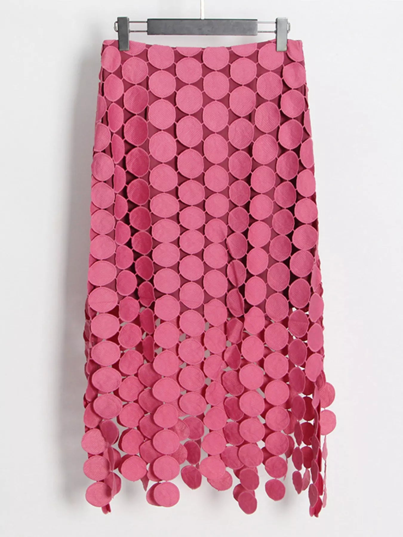 Pink fringe midi skirt with circular cutouts and asymmetrical hem