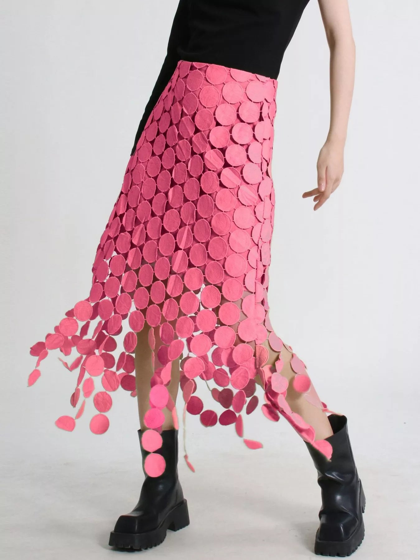 Pink fringe midi skirt with circular cutouts and asymmetrical hem