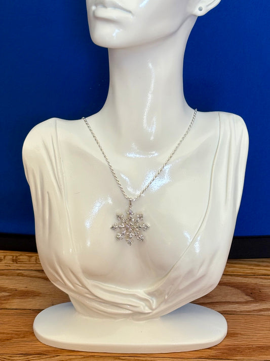 Sterling silver snowflake pendant necklace from the Enchanted Crystals Collection, worn on a matching silver chain.