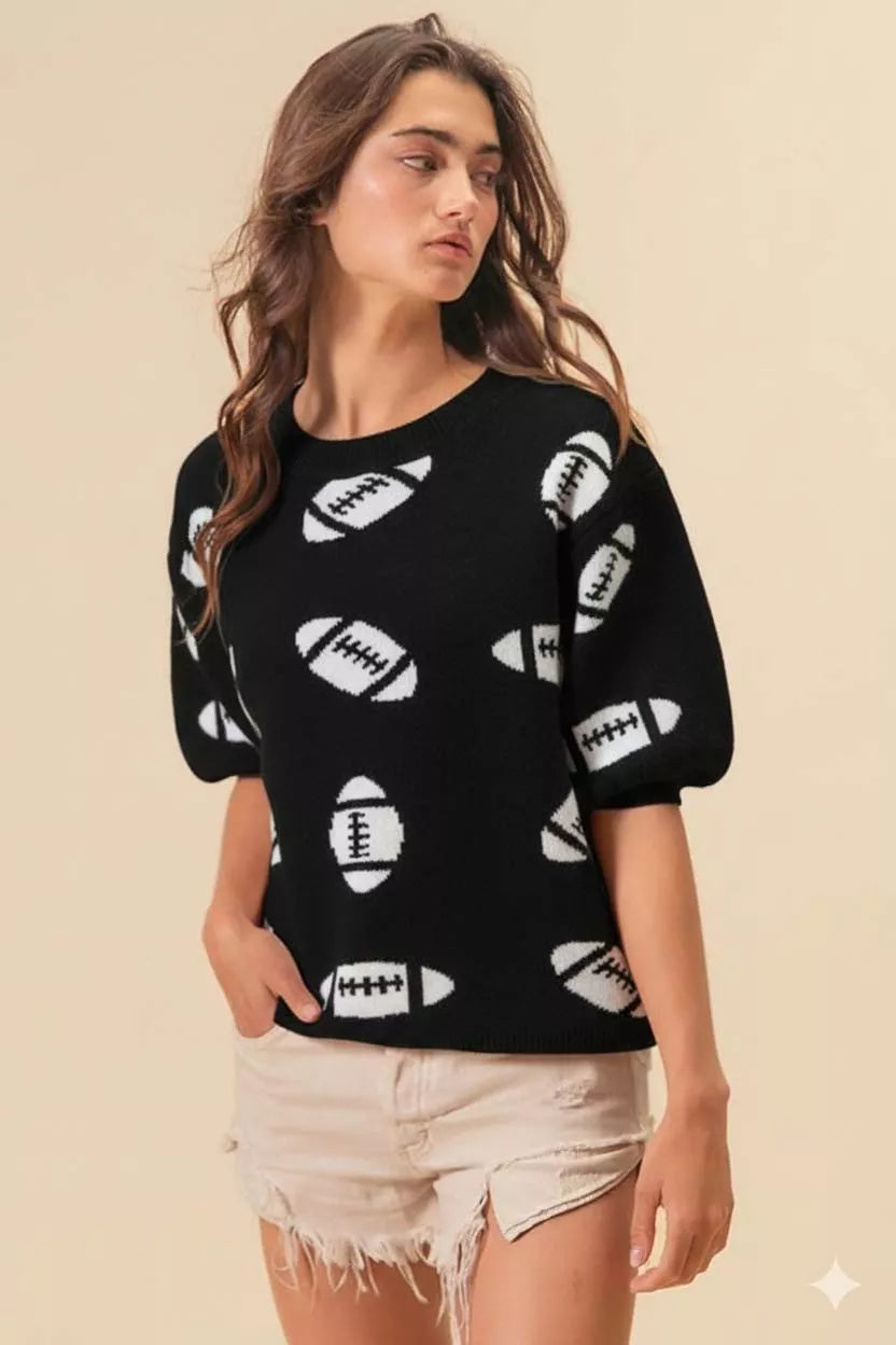Black knit pullover sweater with white football print, relaxed fit, short sleeves, styled for game day.