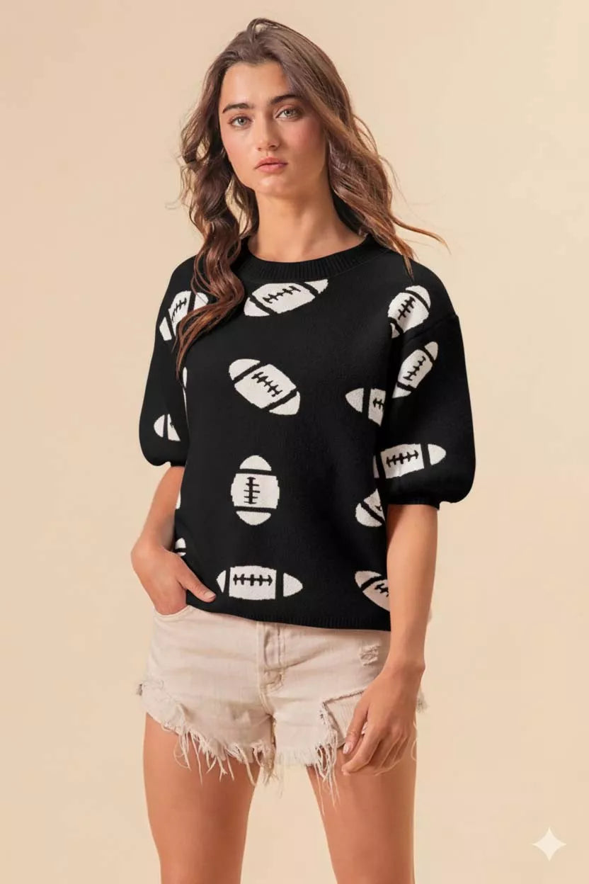 Black knit pullover sweater with white football print, relaxed fit, short sleeves, styled for game day.