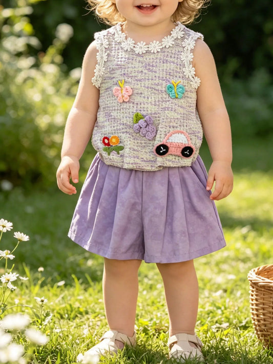 Two-piece baby outfit with textured appliqué sleeveless top, daisy trim neckline, and lavender flowy shorts.