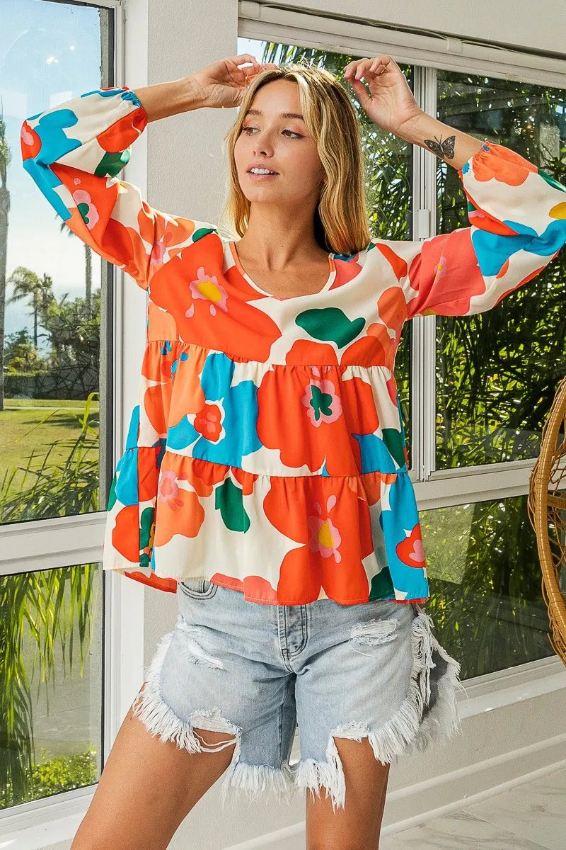 Garden Muse Ruffle Blouse by BiBi – multicolor floral print blouse with V-neckline, tiered ruffles, and elastic cuff sleeves.