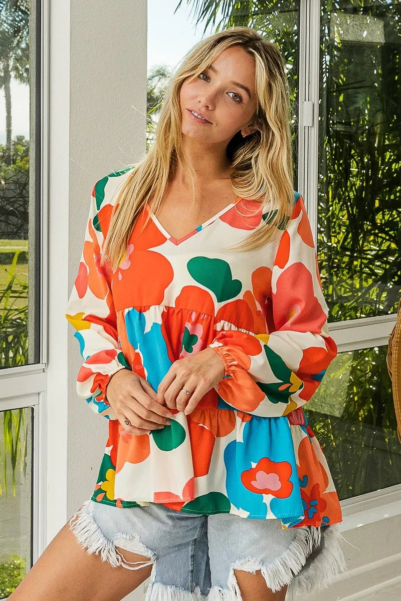 Garden Muse Ruffle Blouse by BiBi – multicolor floral print blouse with V-neckline, tiered ruffles, and elastic cuff sleeves.