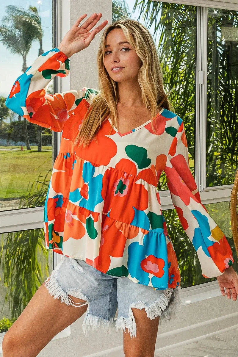 Garden Muse Ruffle Blouse by BiBi – multicolor floral print blouse with V-neckline, tiered ruffles, and elastic cuff sleeves.