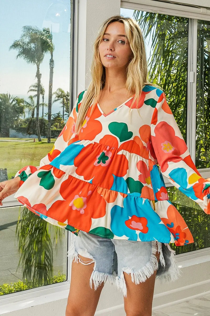 Garden Muse Ruffle Blouse by BiBi – multicolor floral print blouse with V-neckline, tiered ruffles, and elastic cuff sleeves.