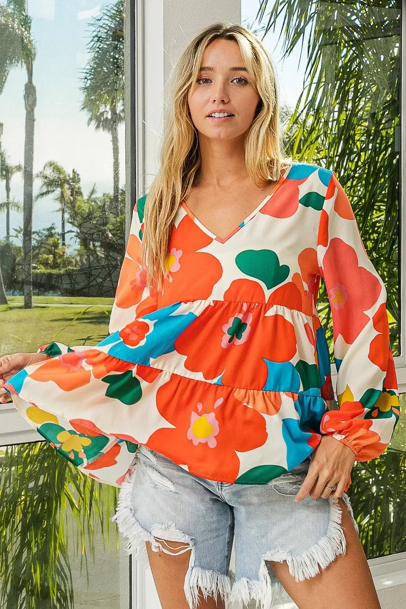 Garden Muse Ruffle Blouse by BiBi – multicolor floral print blouse with V-neckline, tiered ruffles, and elastic cuff sleeves.