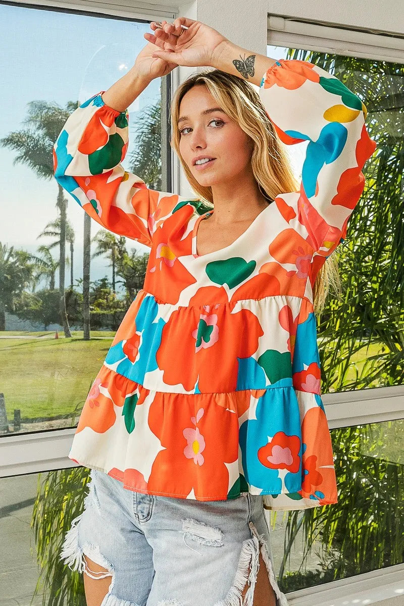 Garden Muse Ruffle Blouse by BiBi – multicolor floral print blouse with V-neckline, tiered ruffles, and elastic cuff sleeves.
