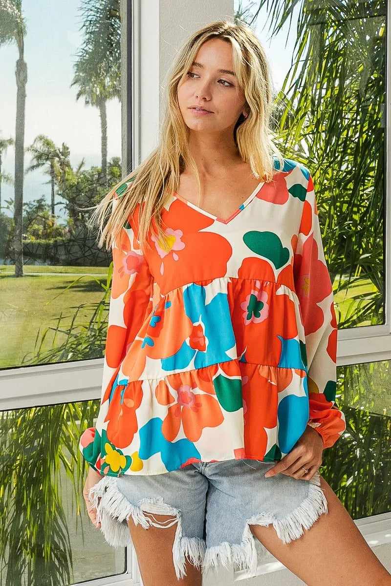 Garden Muse Ruffle Blouse by BiBi – multicolor floral print blouse with V-neckline, tiered ruffles, and elastic cuff sleeves.