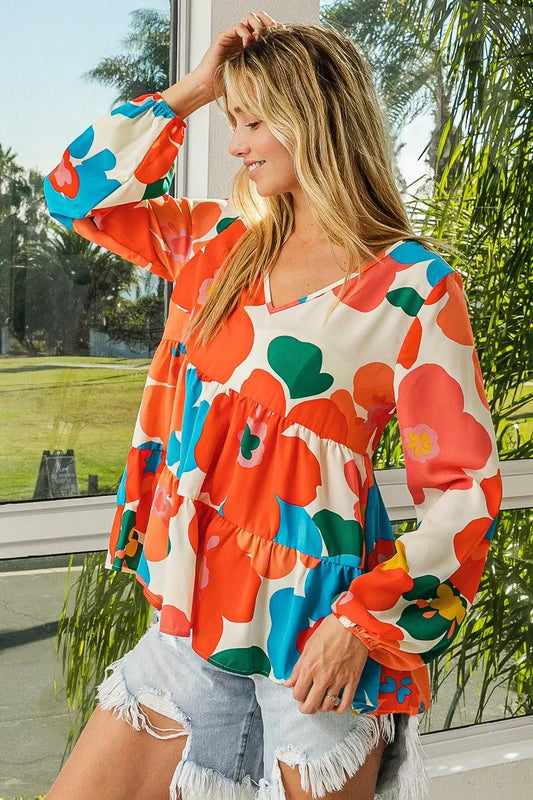 Garden Muse Ruffle Blouse by BiBi – multicolor floral print blouse with V-neckline, tiered ruffles, and elastic cuff sleeves.