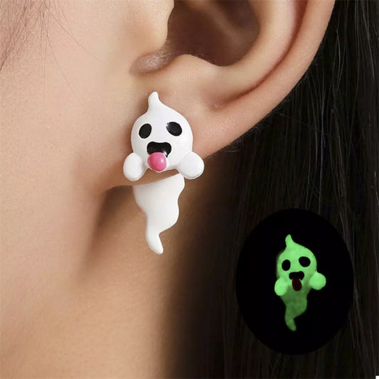 Close-up of a woman wearing glow-in-the-dark ghost earrings featuring white resin ghosts with pink tongues — spooky cute Halloween jewelry from A Whimsical Affair.