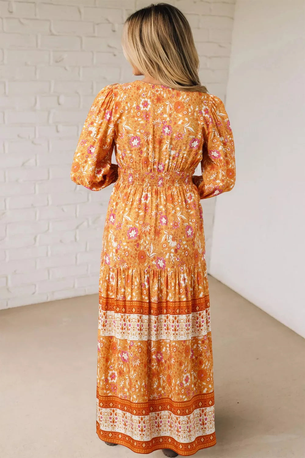 Golden floral smocked boho maxi dress with long sleeves and flowing skirt