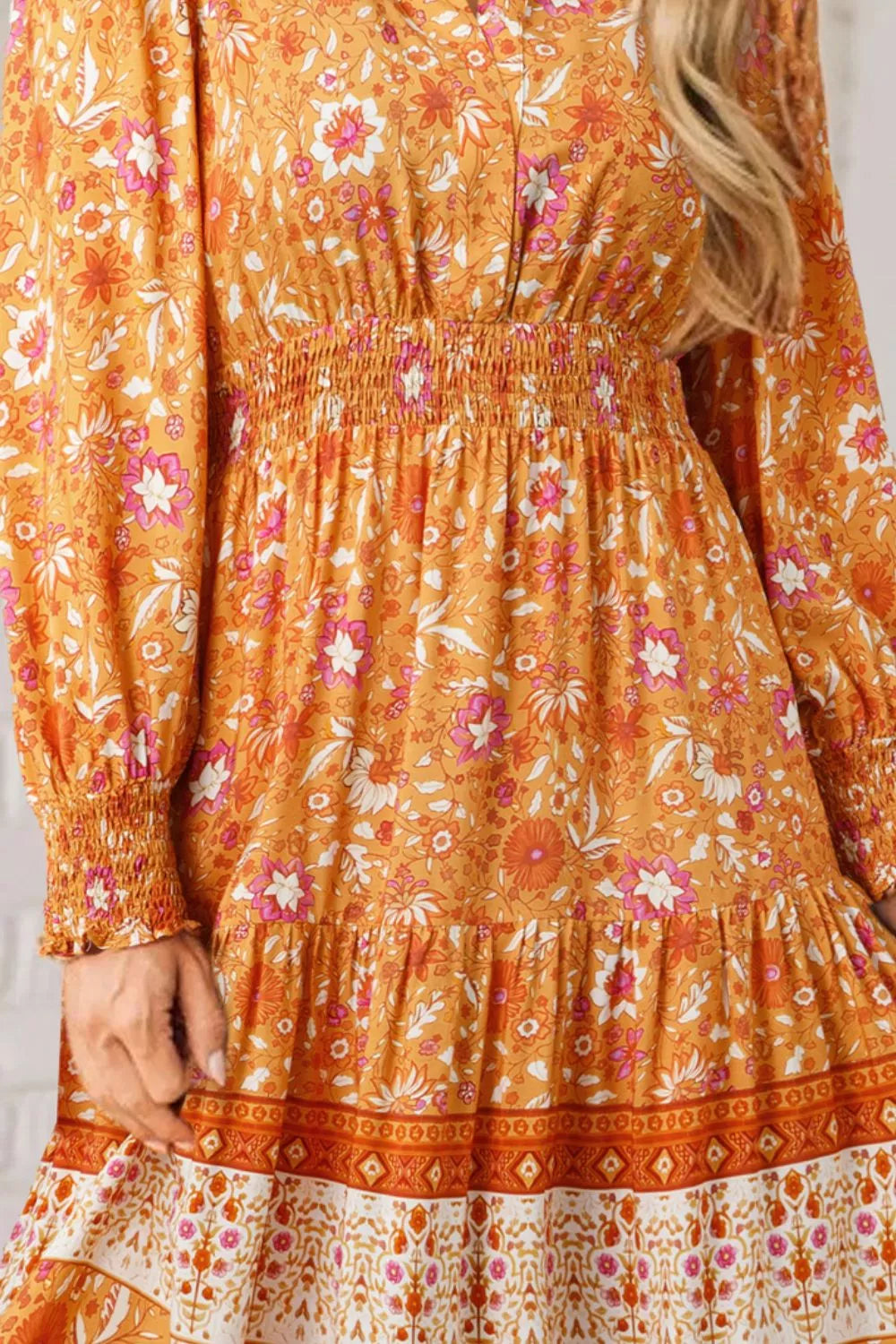 Golden floral smocked boho maxi dress with long sleeves and flowing skirt
