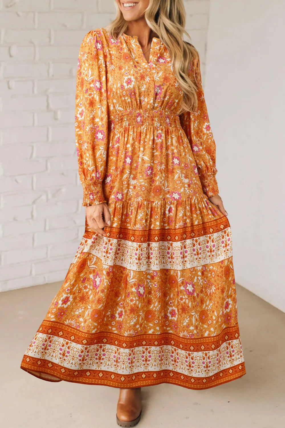 Golden floral smocked boho maxi dress with long sleeves and flowing skirt