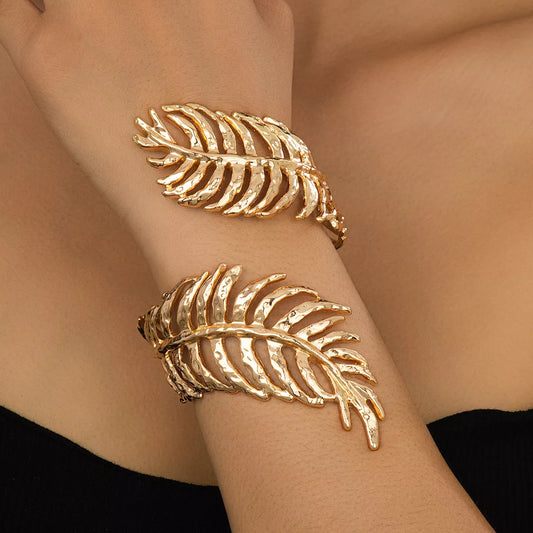18K gold-plated palm leaf cuff bracelet with hammered texture, worn on wrist — elegant boho statement jewelry from A Whimsical Affair.
