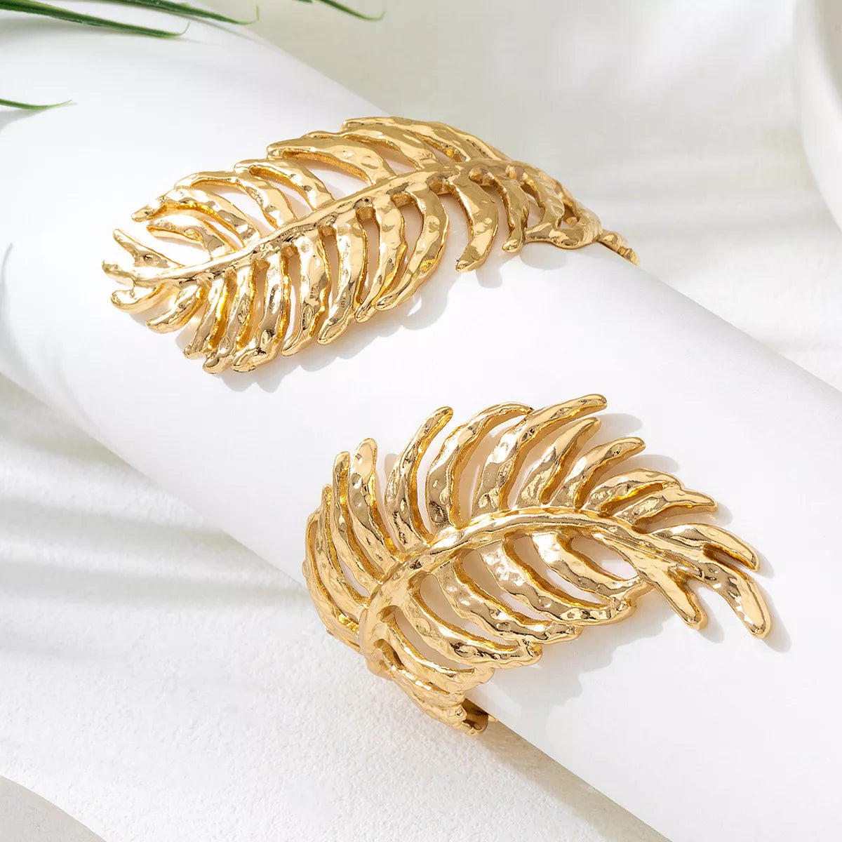 18K gold-plated palm leaf cuff bracelet with hammered texture, worn on wrist — elegant boho statement jewelry from A Whimsical Affair.
