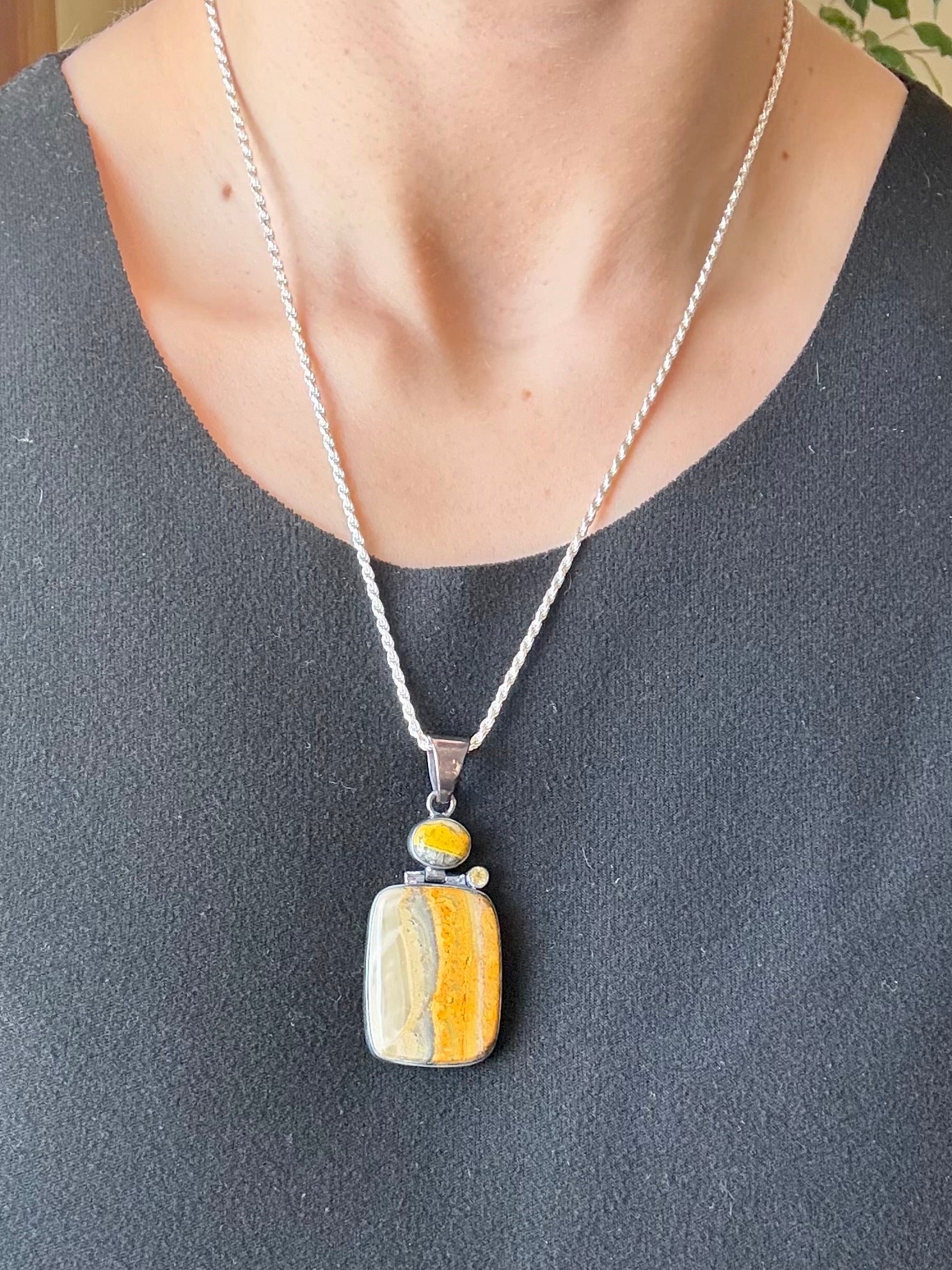 Sterling silver bumble bee jasper pendant featuring natural golden yellow and gray banded stone.