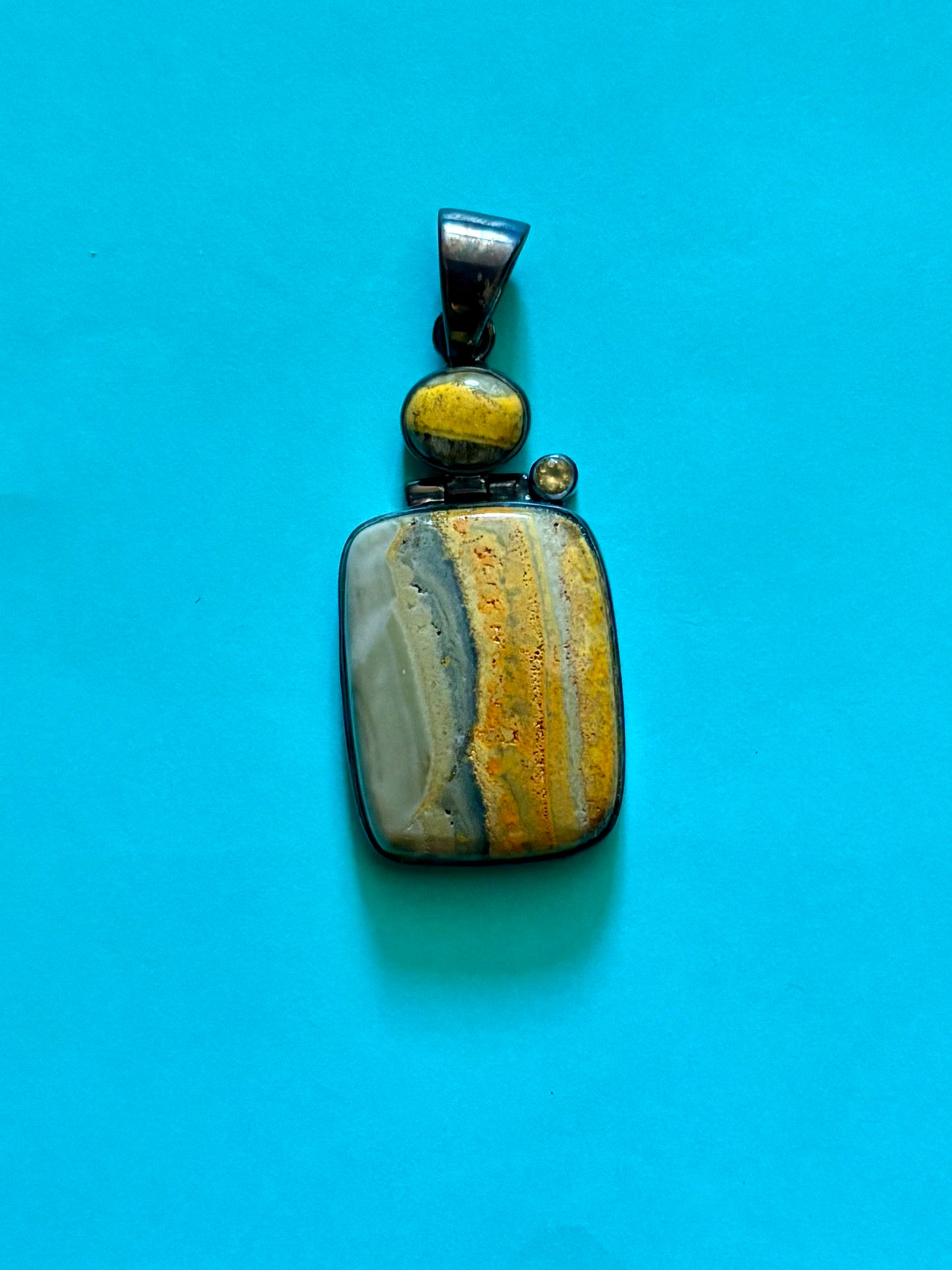Sterling silver bumble bee jasper pendant featuring natural golden yellow and gray banded stone.