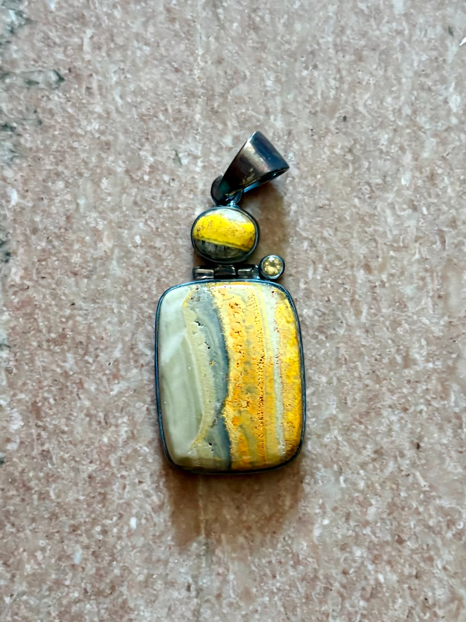 Sterling silver bumble bee jasper pendant featuring natural golden yellow and gray banded stone.