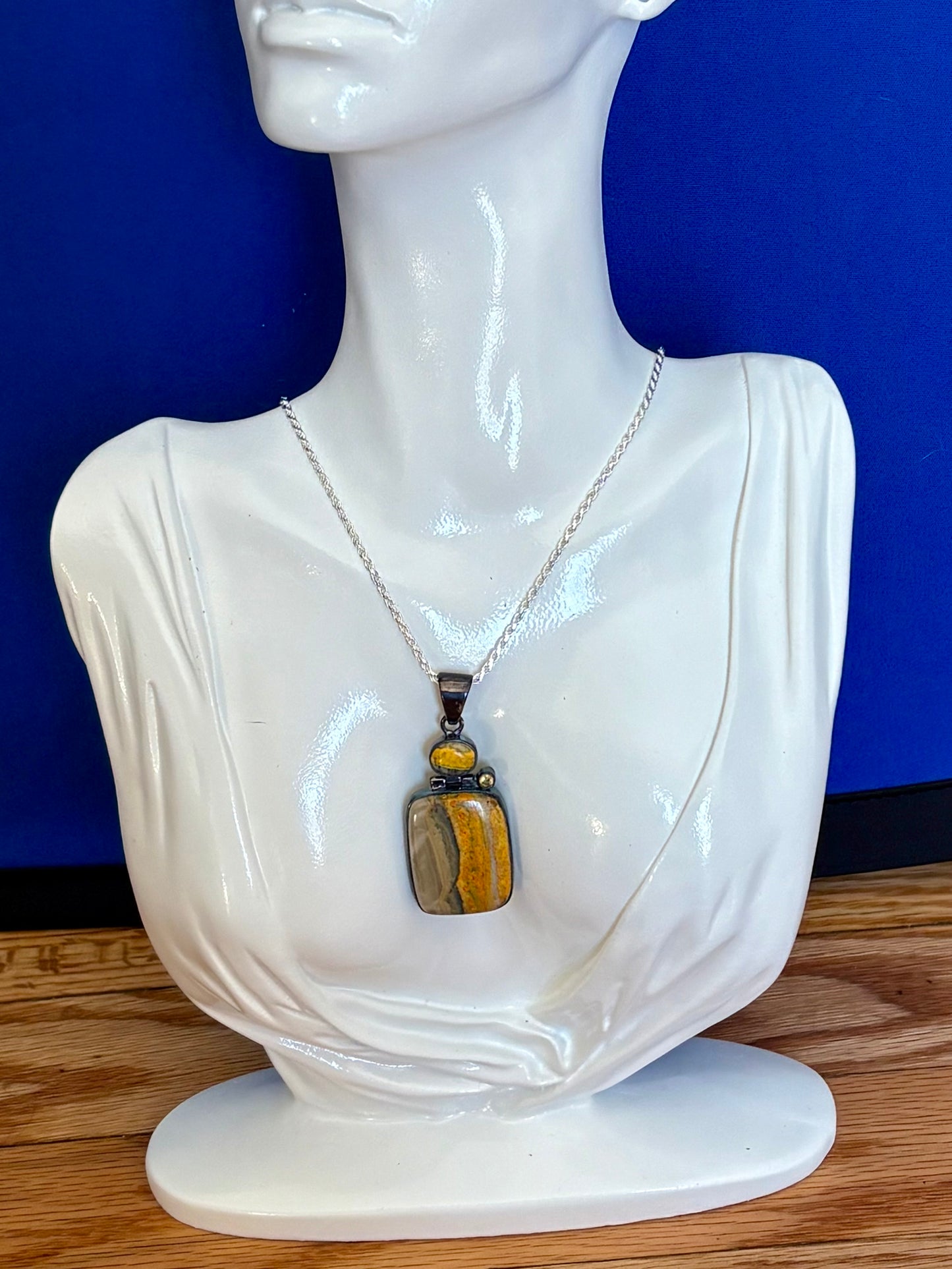 Sterling silver bumble bee jasper pendant featuring natural golden yellow and gray banded stone.