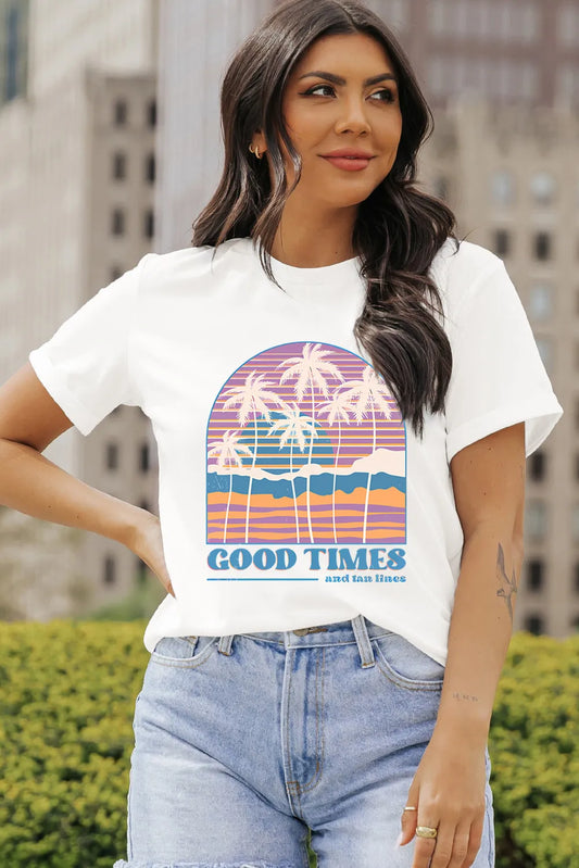 Retro palm tree sunset graphic tee with colorful stripe design styled with denim
