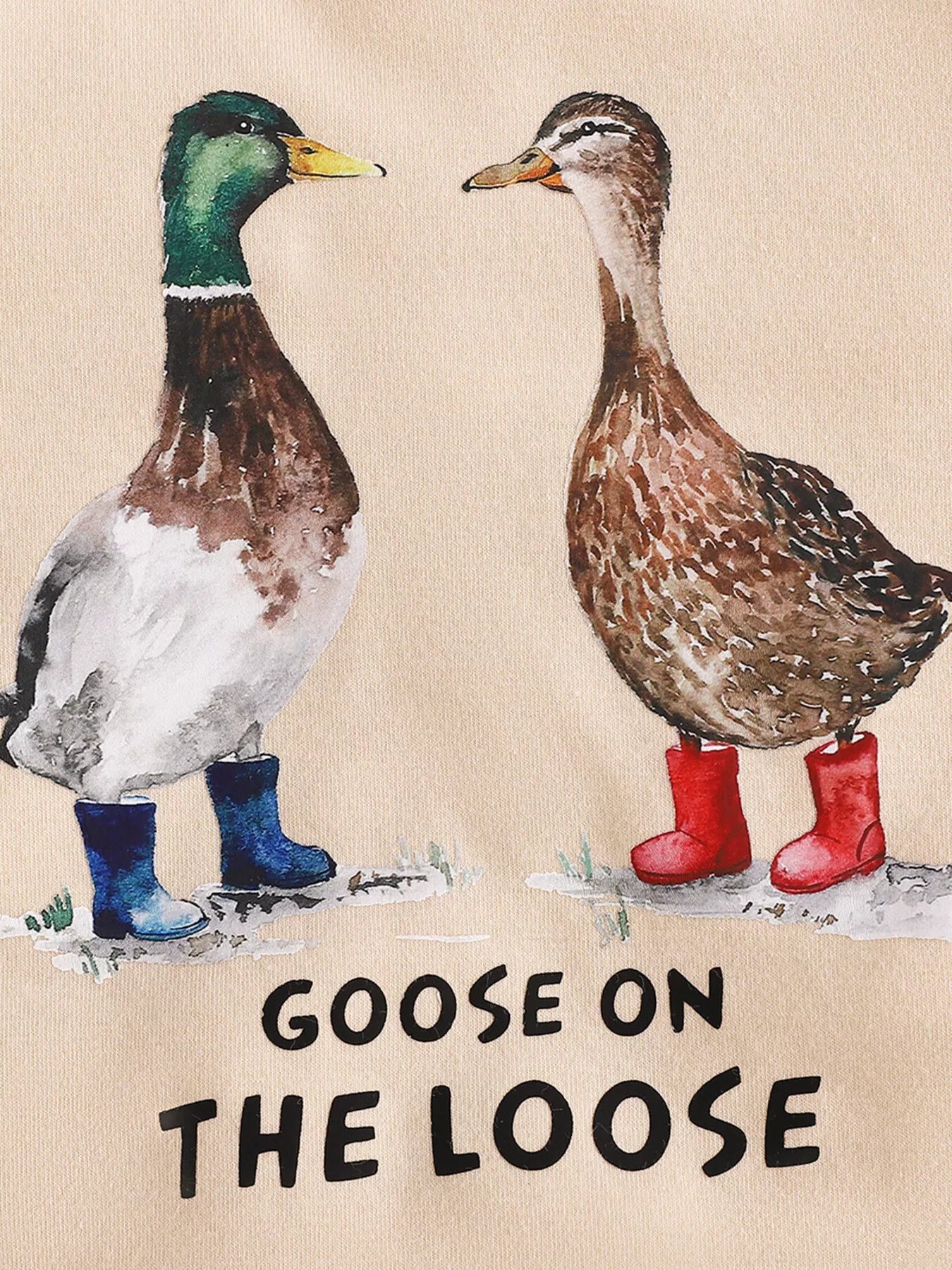 Cream baby romper with “Goose on the Loose” duck graphic, short sleeves, snap bottom, and soft cotton-blend fabric.