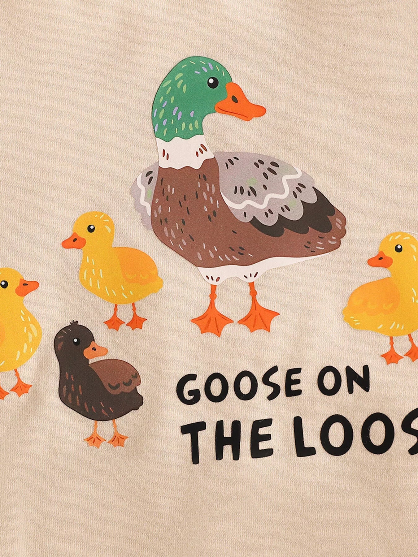 Cream baby romper with “Goose on the Loose” duck graphic, short sleeves, snap bottom, and soft cotton-blend fabric.