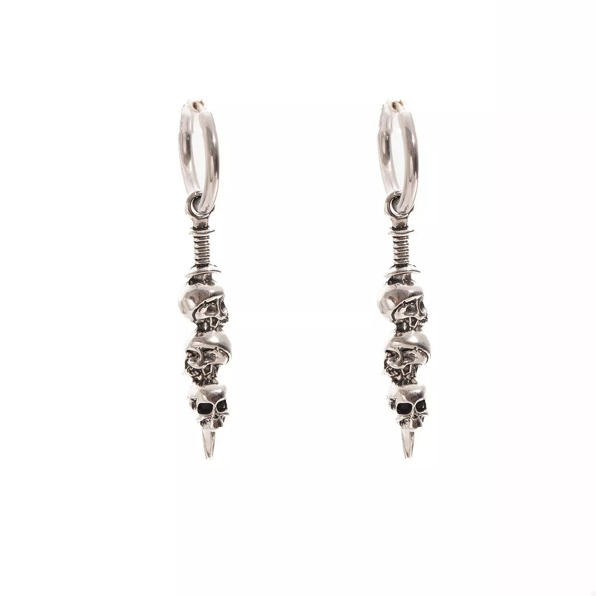 Close-up of silver skull drop earrings with stacked skull design hanging from small hoops — gothic Halloween jewelry from A Whimsical Affair.