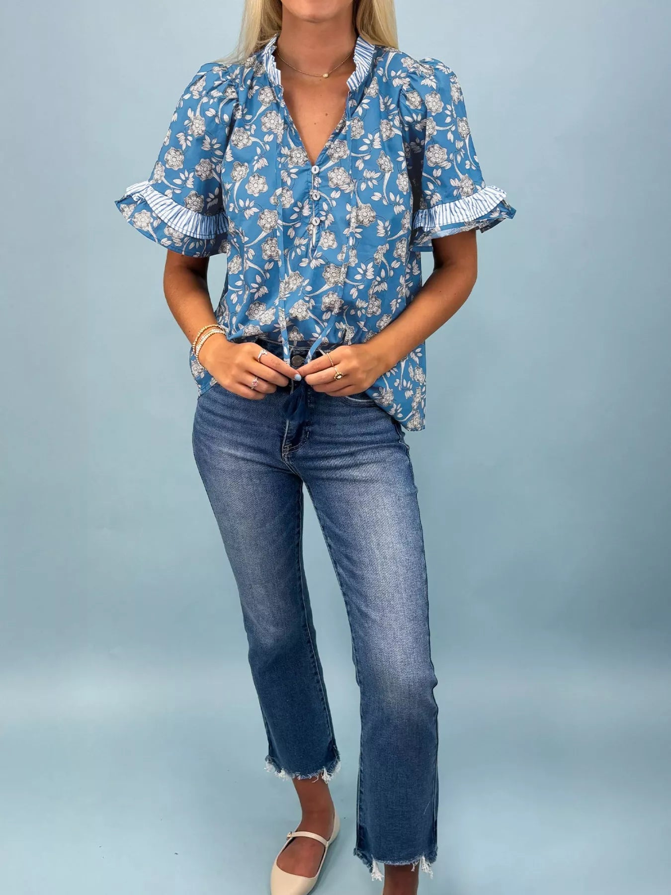 Blue floral cotton blouse with striped ruffle trim and tie neckline