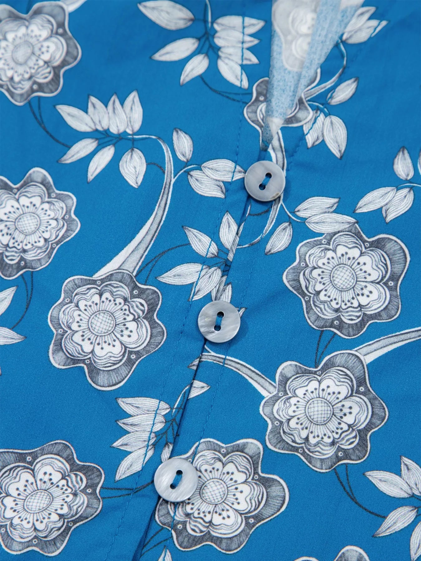 Blue floral cotton blouse with striped ruffle trim and tie neckline