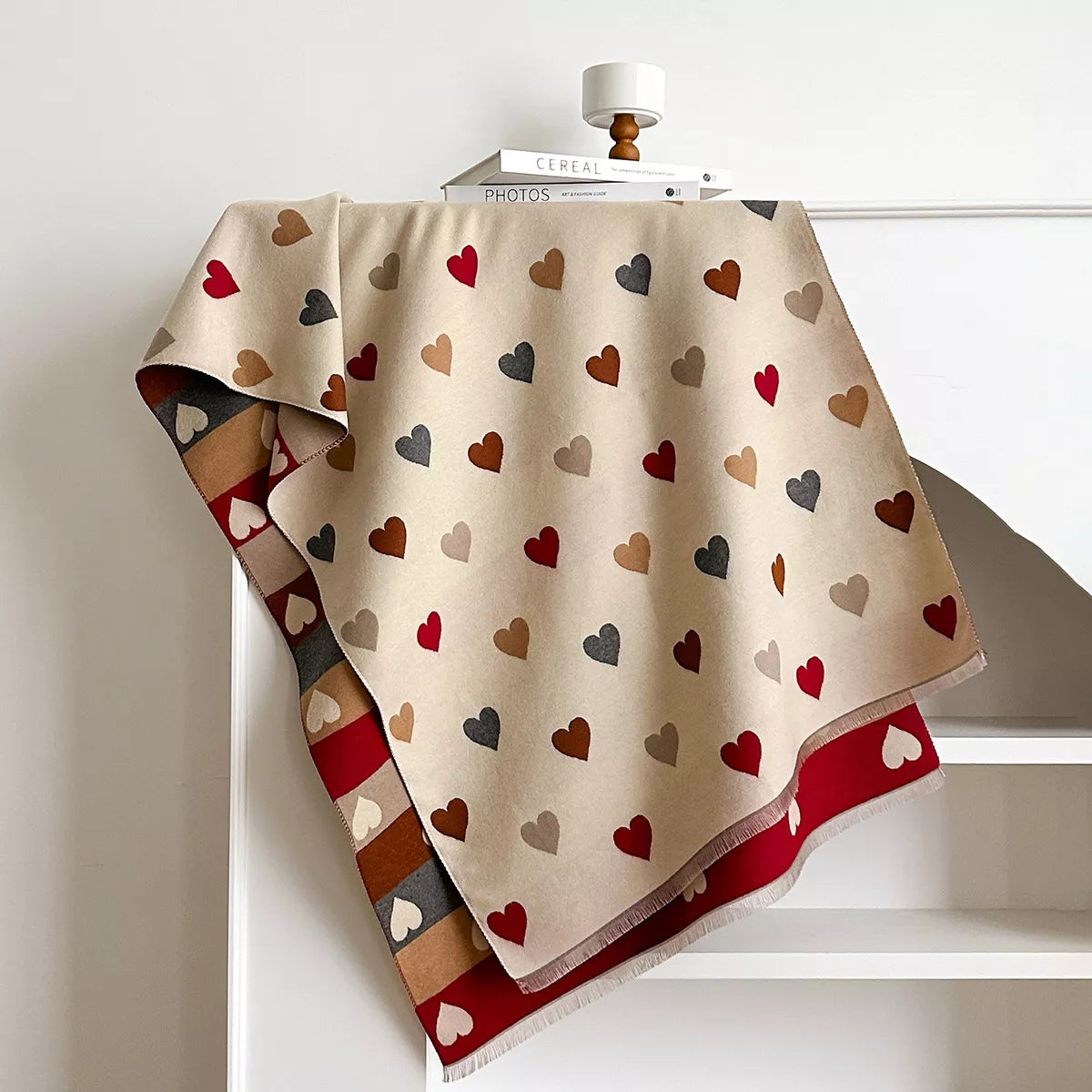 Soft wrap scarf with heart pattern and striped design draped on a dress form