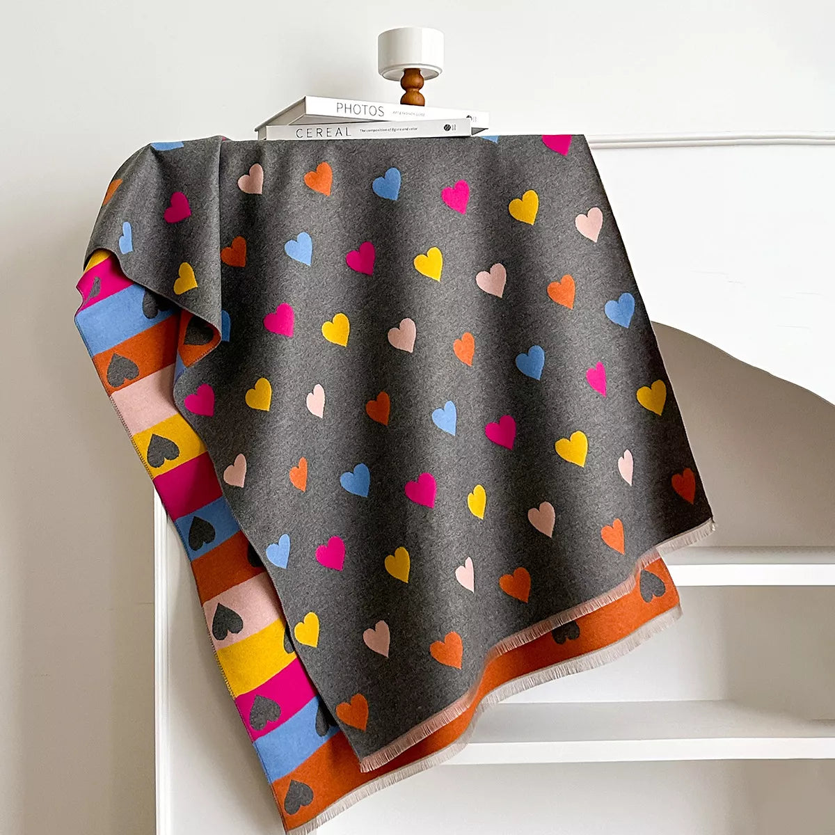 Soft wrap scarf with heart pattern and striped design draped on a dress form