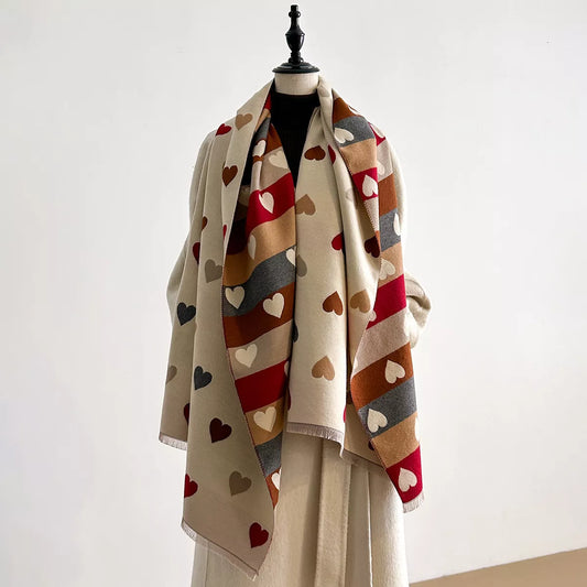 Soft wrap scarf with heart pattern and striped design draped on a dress form