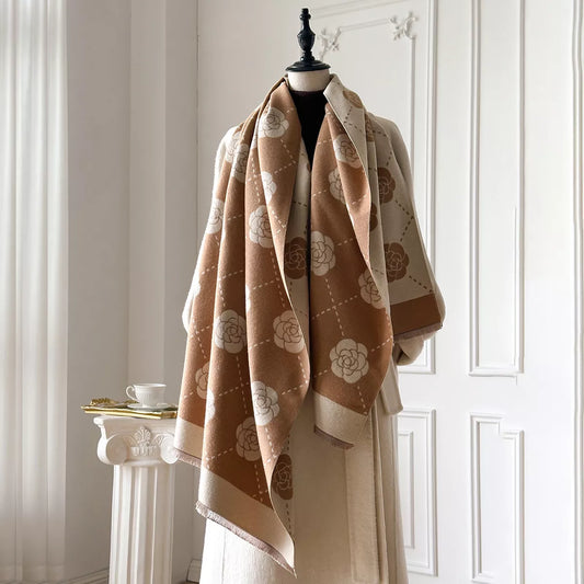 Floral wrap scarf with elegant geometric pattern draped over a neutral coat